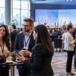 Founders and international business leaders networking at a professional business event and discussing new opportunities.